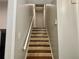 Well-lit staircase with wood and tile flooring at 4132 Scenic Mountain Dr, Snellville, GA 30039