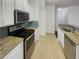 Well-lit kitchen with stainless steel appliances, granite countertops, and tile flooring at 1575 Ridenour Nw Pkwy # 804, Kennesaw, GA 30152