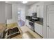 Bright kitchen features stainless steel appliances, granite countertops, and white cabinets at 1575 Ridenour Nw Pkwy # 804, Kennesaw, GA 30152