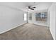 Open bedroom with ceiling fan, bright windows, and neutral carpeting at 1575 Ridenour Nw Pkwy # 804, Kennesaw, GA 30152
