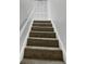 Carpeted stairs ascend towards a white louvered door at 1575 Ridenour Nw Pkwy # 804, Kennesaw, GA 30152