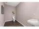 Simple bathroom with toilet, sink, and dark hardwood floor at 8601 Preakness Pass, Lithonia, GA 30058