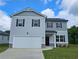 Two-story house with gray siding, white trim, and a two-car garage at 8601 Preakness Pass, Lithonia, GA 30058