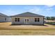 Home exterior showcasing the backyard, patio, and lush green space at 8588 Preakness Pass, Lithonia, GA 30058