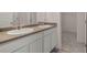 Bathroom featuring double sinks, a large mirror, and a walk-in closet at 8588 Preakness Pass, Lithonia, GA 30058