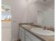 Bathroom featuring double sinks and a mirror with a bedroom in the background at 8588 Preakness Pass, Lithonia, GA 30058