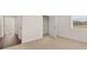 Bedroom featuring neutral carpet, closet, and natural light from the window at 8588 Preakness Pass, Lithonia, GA 30058