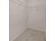 Walk-in closet with a metal shelving unit and carpeted floors at 8588 Preakness Pass, Lithonia, GA 30058