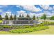 Champions Run community entrance sign with stone accents, landscaping, and water feature under a blue sky at 8588 Preakness Pass, Lithonia, GA 30058