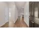 Bright foyer with wood floors leading to an open-concept living area at 8588 Preakness Pass, Lithonia, GA 30058