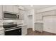 Modern kitchen features stainless steel appliances, granite countertops, and gray cabinets at 8588 Preakness Pass, Lithonia, GA 30058