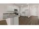 Well-lit kitchen with modern appliances, granite counters, and dark wood flooring at 8588 Preakness Pass, Lithonia, GA 30058
