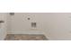 The laundry room features tile floors and access to electrical and plumbing at 8588 Preakness Pass, Lithonia, GA 30058