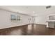 Hardwood floors in a bright living area with sliding glass doors and a partial kitchen view at 8588 Preakness Pass, Lithonia, GA 30058