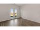 Bright living room with hardwood floors and sliding glass doors leading to a backyard at 8588 Preakness Pass, Lithonia, GA 30058