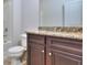 Bathroom vanity featuring dark cabinets, granite countertop, and stylish faucet at 6198 Ripple Way # 87, South Fulton, GA 30349