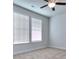 Bedroom with two windows with blinds and ceiling fan at 6198 Ripple Way # 87, South Fulton, GA 30349