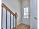 Bright entryway with wood-look floors, stylish staircase, and glass-paned front door at 6198 Ripple Way # 87, South Fulton, GA 30349