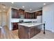 Beautiful kitchen with granite counters, dark cabinetry, stainless appliances, and kitchen island at 6198 Ripple Way # 87, South Fulton, GA 30349