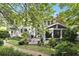Serene backyard with a patio, lush greenery, and a charming white picket fence at 4055 Vinings Mill Se Trl, Smyrna, GA 30080