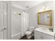 Clean bathroom with white tiles, modern fixtures, and a framed mirror at 4055 Vinings Mill Se Trl, Smyrna, GA 30080