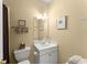 Cozy bathroom featuring a vanity with storage, a mirrored cabinet, and a toilet with white tile flooring at 4055 Vinings Mill Se Trl, Smyrna, GA 30080
