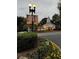 Exterior view of Vinings Jubilee with decorative lamp posts and banners surrounded by colorful flowers at 4055 Vinings Mill Se Trl, Smyrna, GA 30080