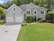 Charming two-story home with a well-manicured lawn and a two-car garage at 4055 Vinings Mill Se Trl, Smyrna, GA 30080