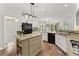 Well-lit kitchen featuring a central island, granite counters and black appliances at 4055 Vinings Mill Se Trl, Smyrna, GA 30080