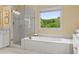 Luxurious main bathroom featuring soaking tub, separate shower, and bright window at 4055 Vinings Mill Se Trl, Smyrna, GA 30080