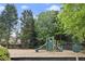 Community playground area features swings, slides, and a soft landing surface for children at 4055 Vinings Mill Se Trl, Smyrna, GA 30080