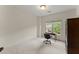 Empty room with a window overlooking lush greenery, featuring a vintage desk and chair at 4055 Vinings Mill Se Trl, Smyrna, GA 30080