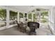 Relaxing sunroom with wicker furniture and views of the surrounding greenery at 4055 Vinings Mill Se Trl, Smyrna, GA 30080