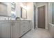 Bathroom with double vanity and grey cabinets at 500 Pearl St, Cumming, GA 30040