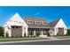 Exterior of charming clubhouse with gray stone and white accents at 500 Pearl St, Cumming, GA 30040