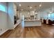 Modern kitchen with white cabinets, island, and hardwood floors at 500 Pearl St, Cumming, GA 30040