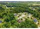 An aerial shot showing houses in a wooded neighborhood with mature trees and well-manicured lawns at 52 Olivia Ct, Palmetto, GA 30268