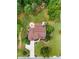 An aerial view showcasing the home's roof, patio areas, fire pit, and beautifully landscaped backyard at 52 Olivia Ct, Palmetto, GA 30268