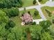 Stunning aerial view of a home with lush green landscaping and a circular driveway on a verdant lot at 52 Olivia Ct, Palmetto, GA 30268