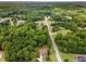 Aerial view of the neighborhood, featuring homes surrounded by lush greenery and mature trees at 52 Olivia Ct, Palmetto, GA 30268