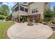 Spacious backyard with a stone patio, fire pit, and lush landscaping perfect for outdoor entertaining at 52 Olivia Ct, Palmetto, GA 30268