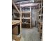 Unfinished basement with wood shelving and a concrete floor offering storage space or potential to customize at 52 Olivia Ct, Palmetto, GA 30268