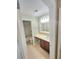 Bathroom featuring a vanity with storage, a framed mirror, and a shower-tub combo, offering functionality and style at 52 Olivia Ct, Palmetto, GA 30268