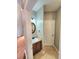 Bathroom with a vanity featuring brown cabinets, an oval mirror and a white door at 52 Olivia Ct, Palmetto, GA 30268