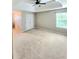 Spacious bedroom features a tray ceiling with a ceiling fan and a window, creating a tranquil and inviting atmosphere at 52 Olivia Ct, Palmetto, GA 30268