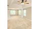 Bright bedroom featuring tray ceiling, fan, and large windows at 52 Olivia Ct, Palmetto, GA 30268