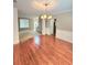 Dining room with hardwood floors, wainscoting, a chandelier, and an adjoining living area at 52 Olivia Ct, Palmetto, GA 30268