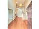 Bright foyer showcasing a staircase with wooden railings and gleaming hardwood floors upon entry at 52 Olivia Ct, Palmetto, GA 30268