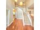 Open-concept foyer features a staircase with wooden railings, a high ceiling, and new-looking carpet at 52 Olivia Ct, Palmetto, GA 30268