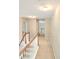 Hallway with carpet flooring and wood railing providing safety and aesthetic appeal on the upper level at 52 Olivia Ct, Palmetto, GA 30268